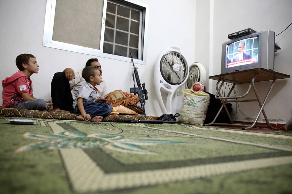  An unhappy compromise. A Free Syrian Army fighter watches Obama's speech in Ghouta, 2013. Photo credit: REUTERS/Mohamed Abdullah