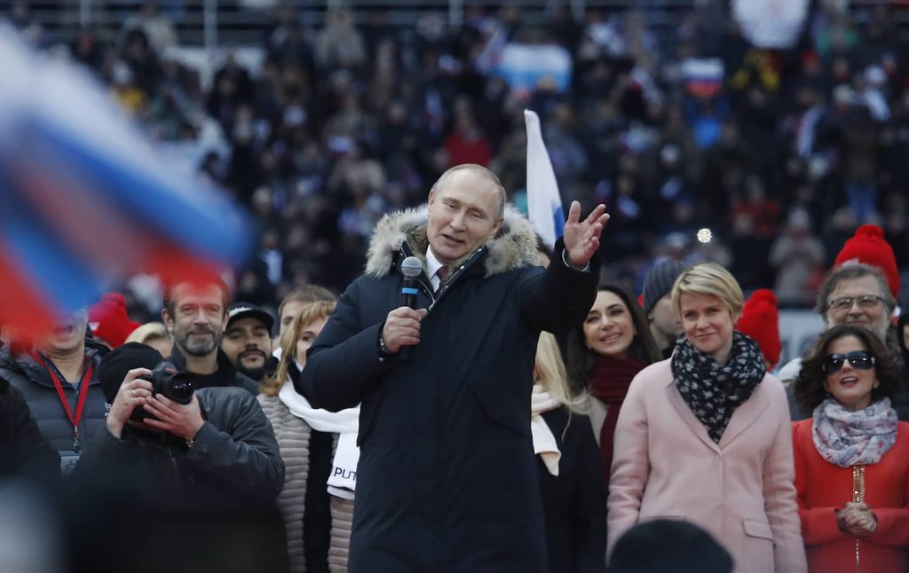 Russian President Putin delivers a speech during a rally to support his bid in the upcoming presidential election. Photo credit: REUTERS