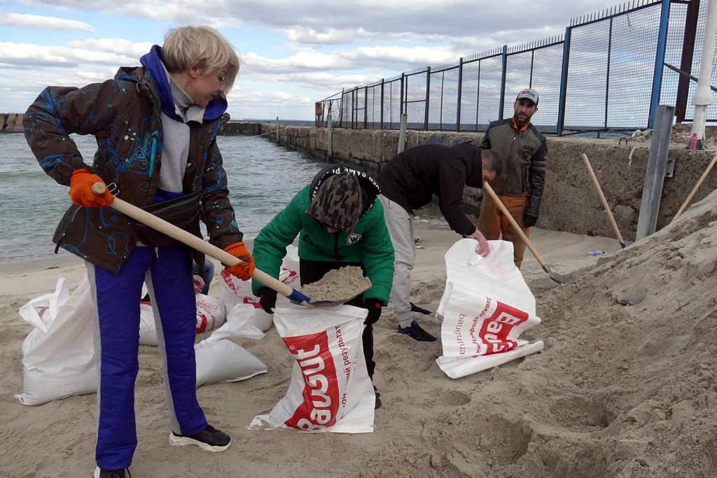 Odessa residents fill bags with sand to defend the city. Photo credit: Yulii Zozulia via Reuters Connect