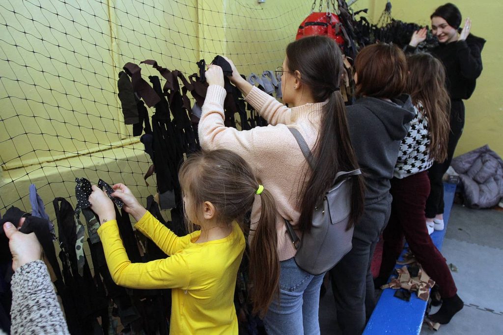 Dnipro residents weave camouflage nets. Photo credit: Mykola Myakshykov via Reuters Connect