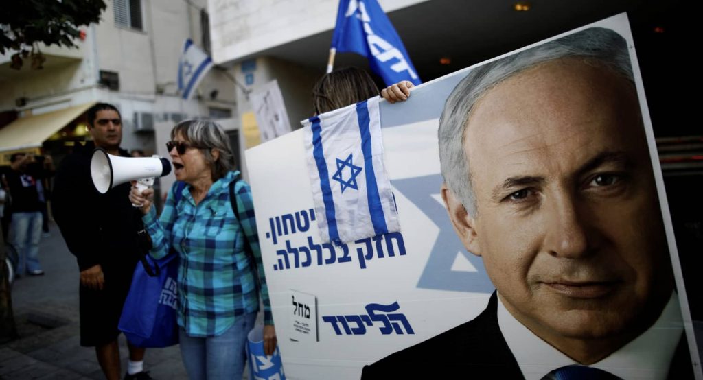 Supporters of Israeli Prime Minister Benjamin Netanyahu. The placards in Hebrew read, "Strong in security, strong in Economy ". Photo credit: REUTERS