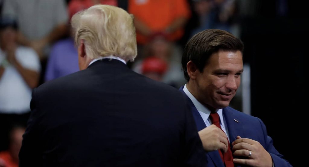 Governor Ron DeSantis gets ready to speak during a campaign rally former US President Donald Trump in Florida, October 2018. Photo credit: REUTERS