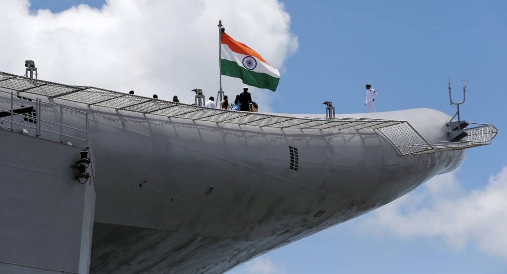 Indian Navy officers stand on the flight deck of India's first home-built aircraft carrier INS Vikrant in Kochi, India, September 2022. Photo credit: REUTERS