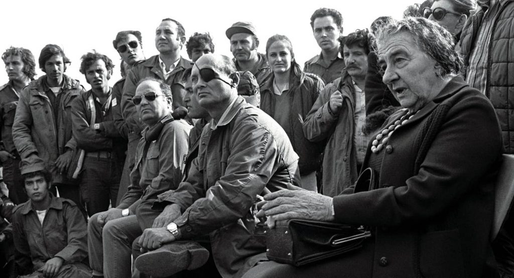 Prime Minister Golda Meir, accompanied by Defense Minister Moshe Dayan, meets with Israeli soldiers at a base on the Golan Heights during the 1973 Yom Kippur War. Photo credit: REUTERS