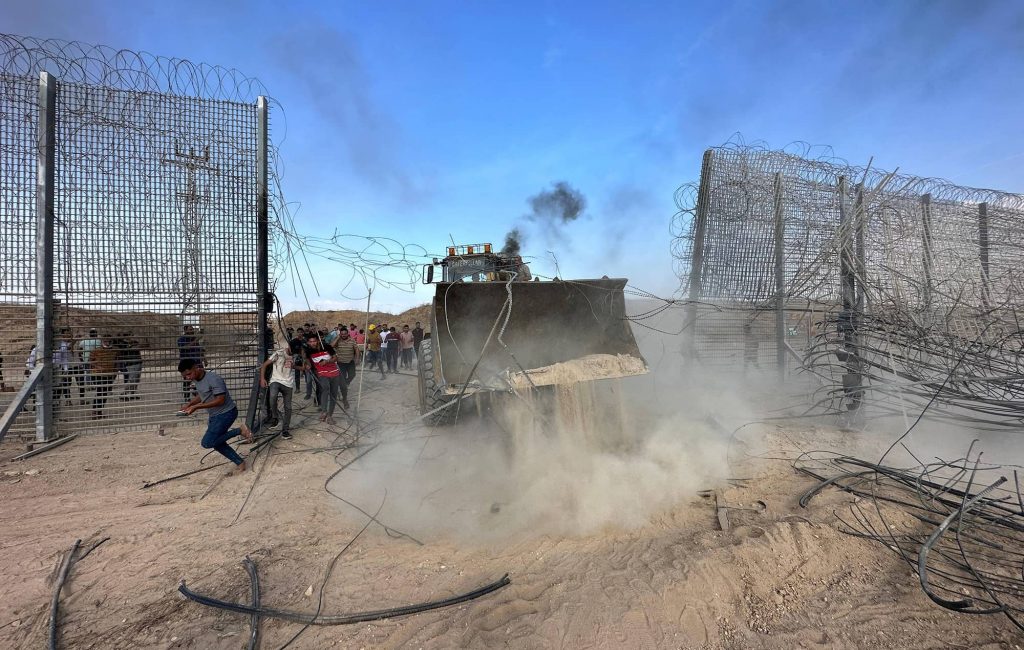 Palestinians crossing the border fence with Israel from Khan Yunis in the southern Gaza Strip, October 7, 2023. Photo credit: IMAGO/APAimages via Reuters Connect