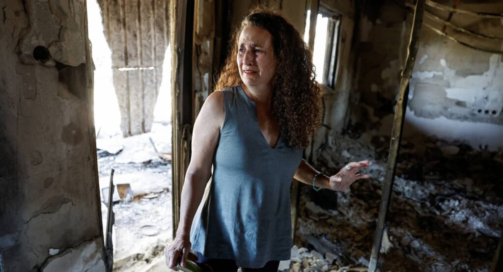 Hadas Kalderon, whose family members were killed and kidnapped on October 7, in the burned-out remains of her mother’s home, Kibbutz Nir Oz, October 30, 2023. Photo credit: REUTERS/Evelyn Hockstein.