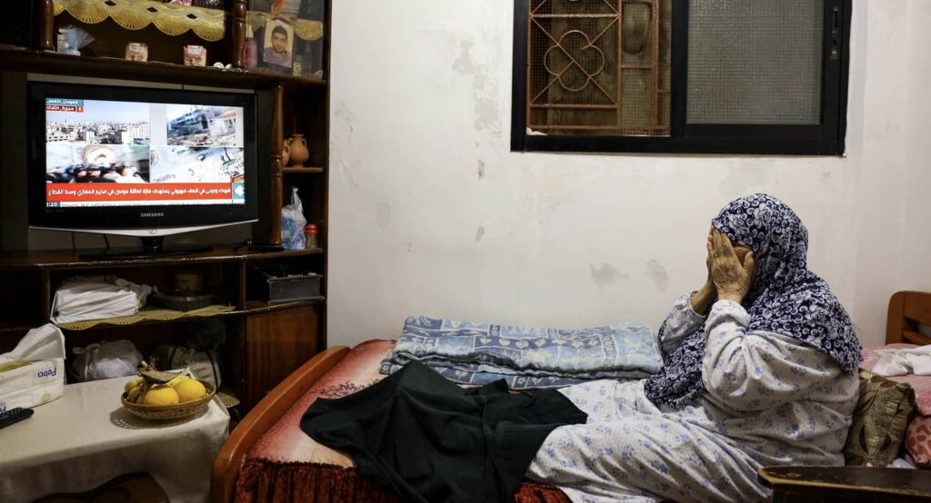 A Palestinian refugee watching Gaza news on television in Bourj al-Barajneh Refugee Camp in Beirut, Lebanon, October 25, 2023. Photo credit: REUTERS/Amr Alfiky.