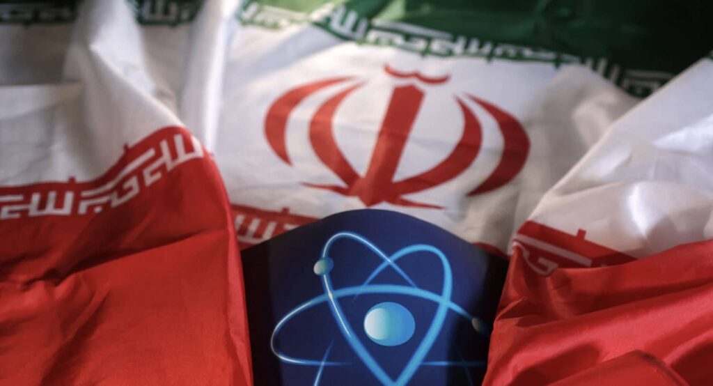 Illustration shows atomic symbol and Iranian flag.